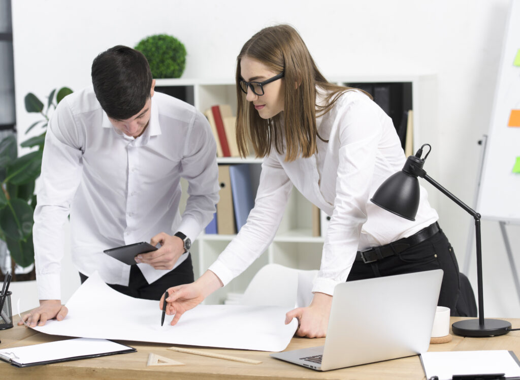 young businesswoman discussing project with her male colleague white paper desk